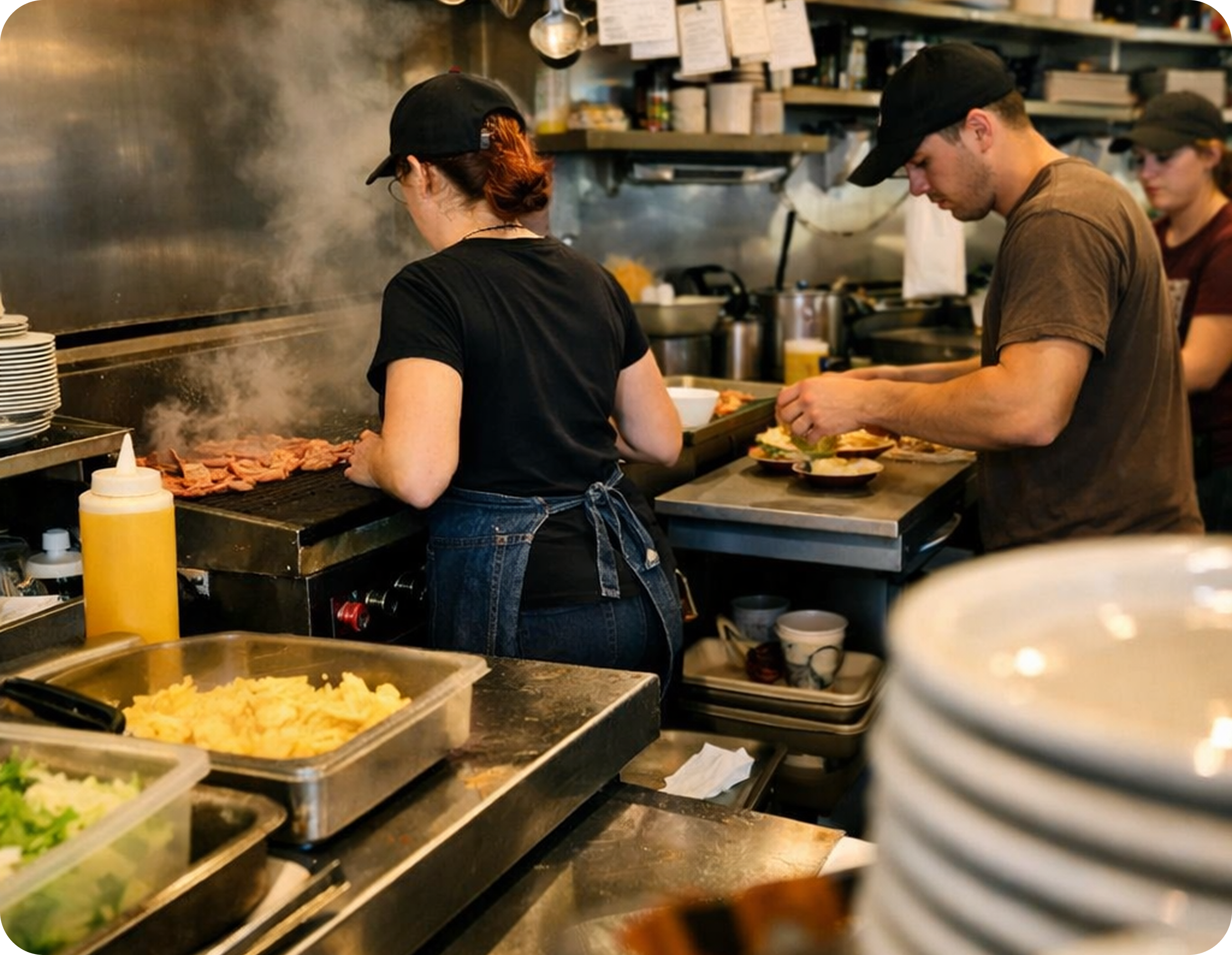 Restaurant team preparing food in a busy kitchen